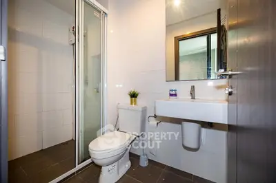 Modern bathroom with sleek fixtures and glass shower enclosure
