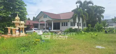 Charming suburban home with lush garden and traditional spirit house, perfect for family living.