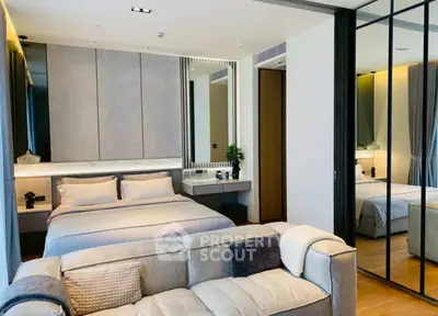 Luxurious modern bedroom with cozy sofa and mirrored wardrobe