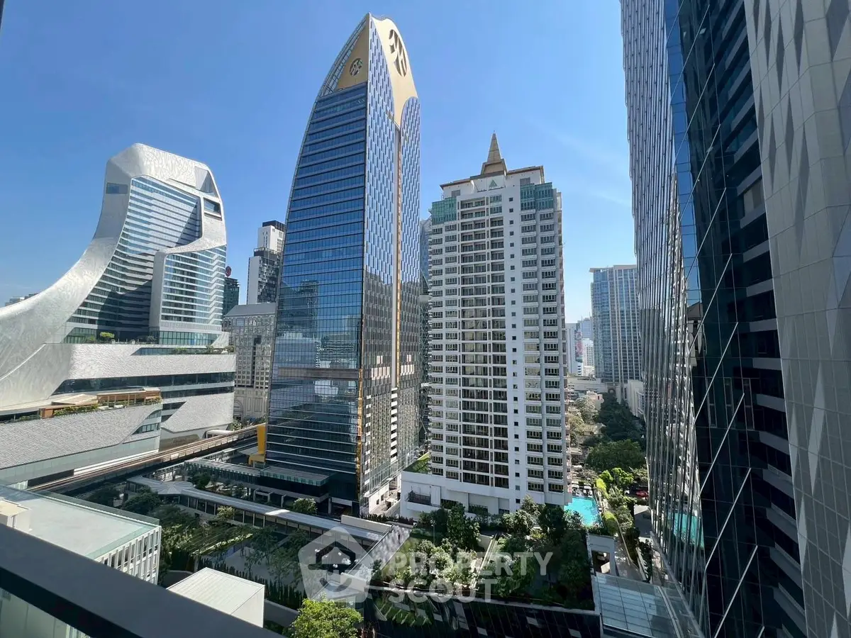Stunning cityscape view from a high-rise balcony showcasing modern architecture and lush greenery.