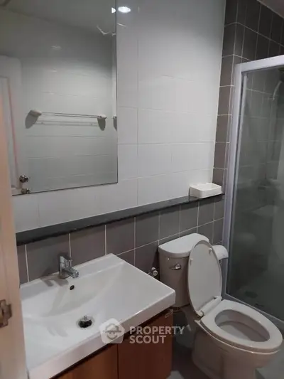 Modern bathroom with sleek fixtures and glass shower enclosure