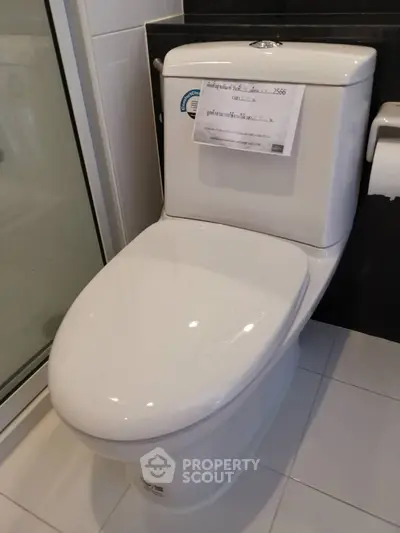 Modern bathroom with sleek toilet and glass shower enclosure