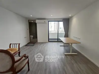 Spacious modern living room with balcony access and elegant seating