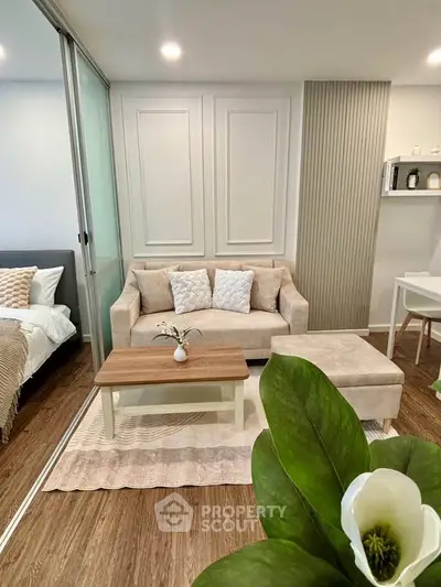 Modern living room with cozy beige sofa, stylish coffee table, and elegant decor in a contemporary apartment.