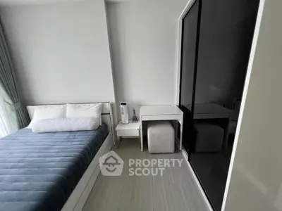 Modern minimalist bedroom with sleek design and ample natural light.