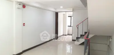 Spacious interior hallway with modern staircase and natural light
