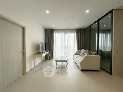 Modern living room with elegant furniture and large windows offering a stunning view.