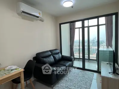 Modern living room with black leather sofa and balcony view