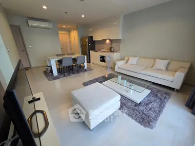 Spacious modern living room with open kitchen and elegant furnishings