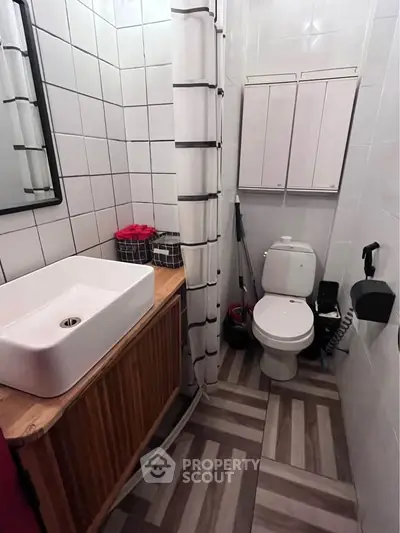 Chic modern bathroom with stylish sink and tiled walls, perfect for urban living.