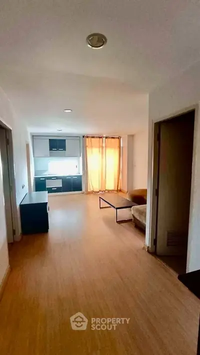 Spacious open-plan living area with modern kitchen and natural light