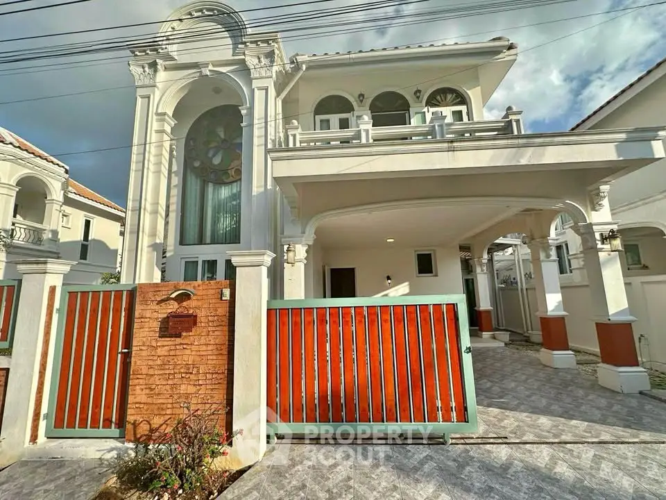 Stunning two-story Mediterranean-style villa with elegant arches and spacious driveway.