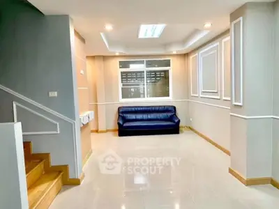 Spacious living room with modern decor and blue sofa