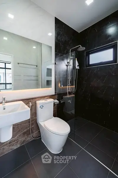 Modern bathroom with sleek black tiles and contemporary fixtures