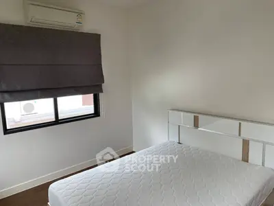 Cozy bedroom with air conditioning and modern decor, perfect for comfort and relaxation.