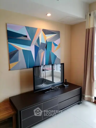 Modern living room with abstract art and sleek TV setup