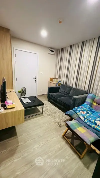 Cozy living room with modern decor and comfortable seating in a stylish apartment.