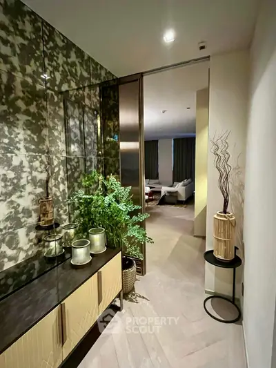 Stylish hallway leading to a modern living room with elegant decor and ambient lighting.