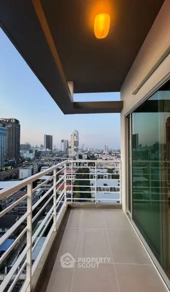 Stunning city view from a modern balcony in a high-rise apartment.