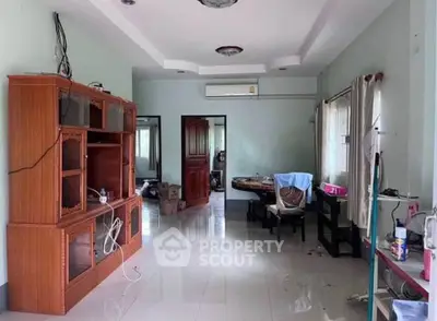 Spacious living room with modern furniture and natural light, perfect for family gatherings.