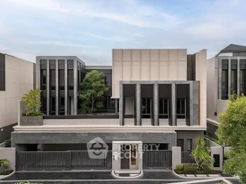 Modern luxury residential building with sleek architectural design and lush greenery.