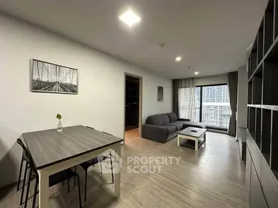 Modern living room with sleek furniture and city view balcony