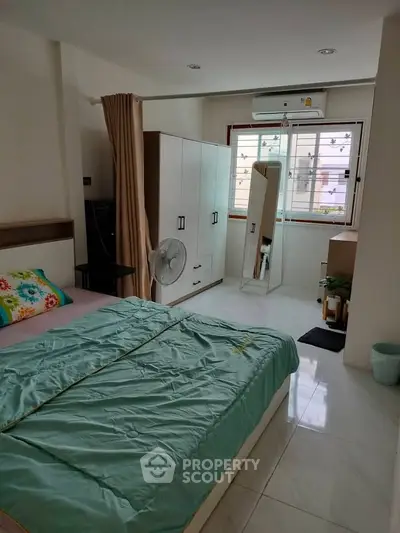Spacious bedroom with modern decor and natural light