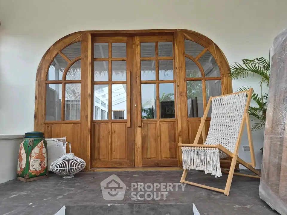 Charming wooden entrance with stylish chair and decor accents