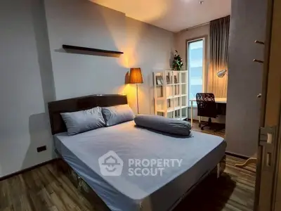 Cozy bedroom with modern decor and study area, perfect for relaxation and productivity.