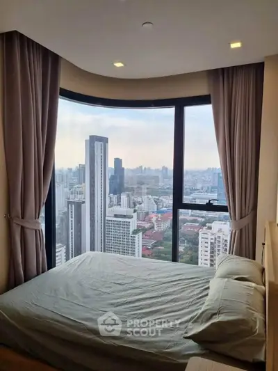 Luxurious bedroom with panoramic city view from high-rise apartment