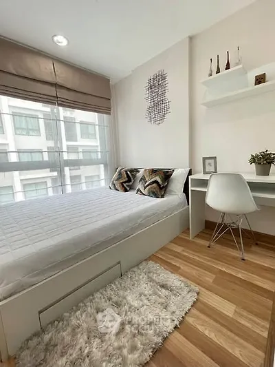 Modern bedroom with stylish decor and workspace in a bright apartment