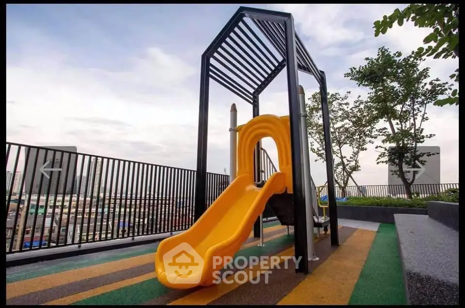 Modern rooftop playground with slide and city view, perfect for family-friendly living.