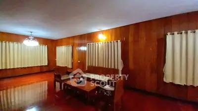 Spacious wooden living room with elegant furniture and warm lighting.