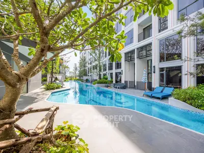 Luxurious apartment complex with stunning pool and lush greenery, perfect for relaxation and leisure.
