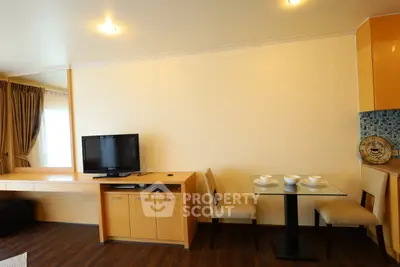 Modern living room with TV and dining area in stylish apartment