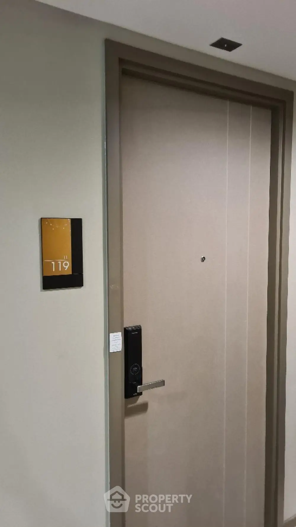 Modern apartment entrance with digital lock and room number 119