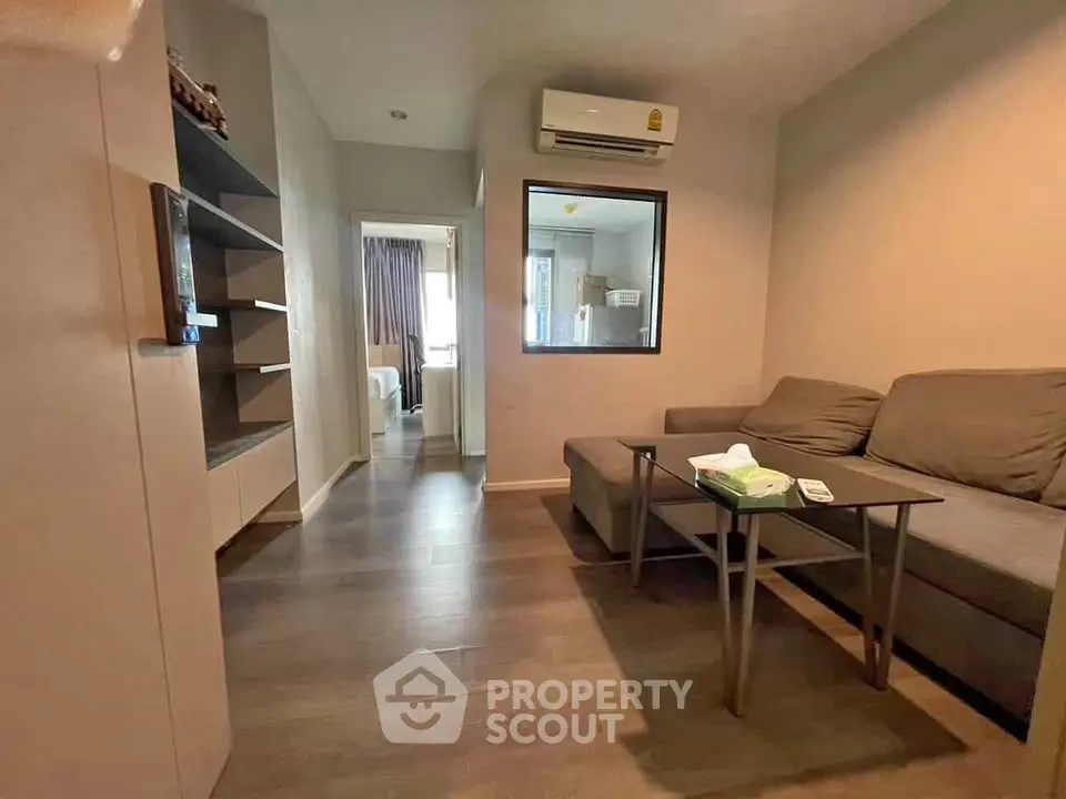 Cozy living room with modern furnishings and air conditioning in a stylish apartment.
