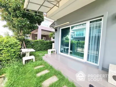 Charming garden patio with sliding glass doors and lush greenery