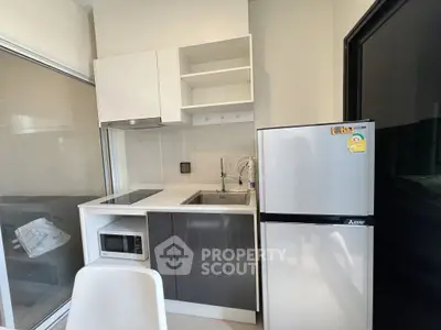 Modern compact kitchen with sleek appliances and minimalist design