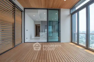 Luxurious high-rise apartment with spacious balcony and stunning city view.