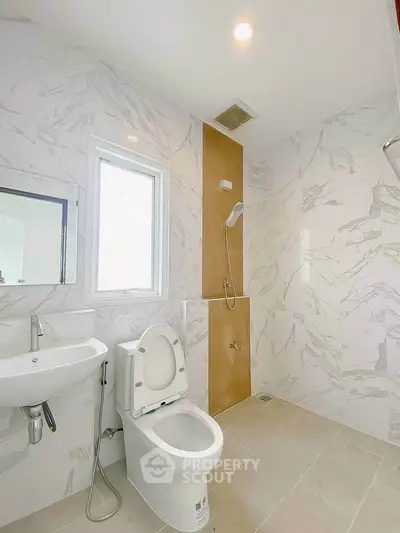 Modern bathroom with marble walls and sleek fixtures