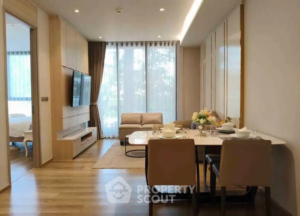 Modern living room with dining area and large windows in stylish apartment