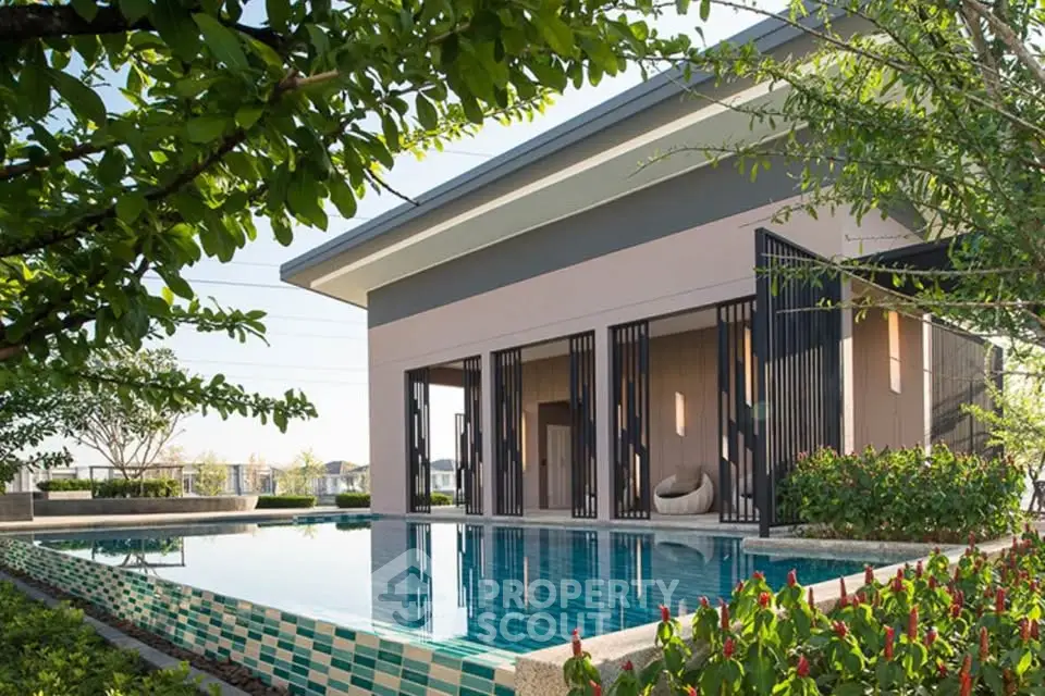Modern luxury home with sleek pool and lush garden, perfect for relaxation and entertainment.