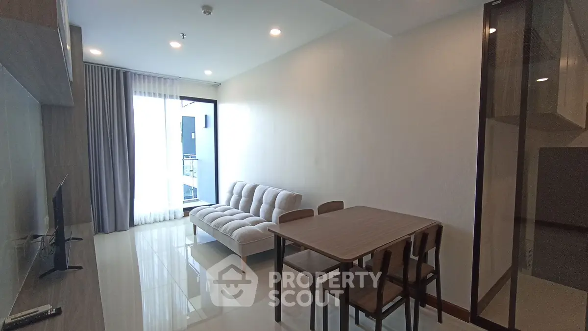 Modern living room with sleek furniture and natural light, perfect for urban living.