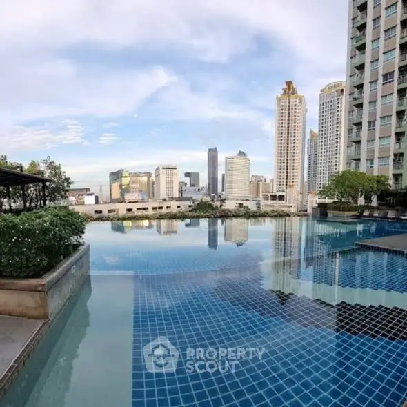 Stunning rooftop pool with city skyline view in luxury high-rise building.