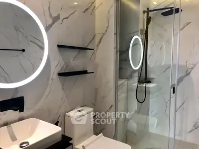 Luxurious modern bathroom with marble walls and sleek fixtures