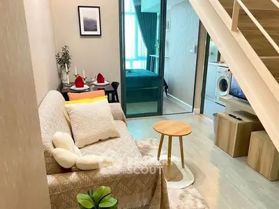 Charming duplex living room with cozy decor and modern laundry area.