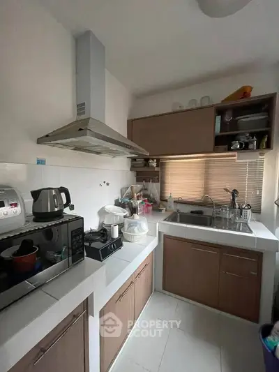 Cozy kitchen with modern appliances and ample storage in a compact layout.
