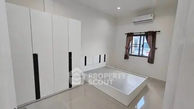 Spacious modern bedroom with minimalist design and large wardrobe