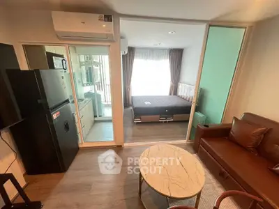 Modern studio apartment with open layout, featuring a cozy living area, compact kitchen, and stylish bedroom.